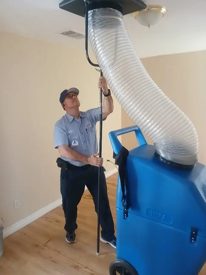 Furnace Tune-Up technician using HEPA equipment in Concord